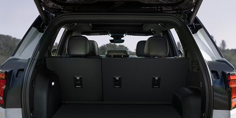 Rear cargo space of the 2025 GMC Acadia with seats folded down.